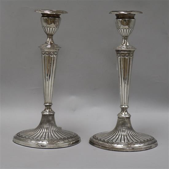 A pair of silver plated candlesticks height 28cm